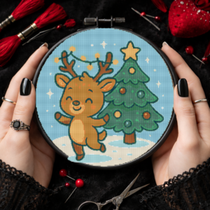 A small deer with a garland on its antlers dances in the snow next to a decorated Christmas tree - Cross stitch pattern PDF